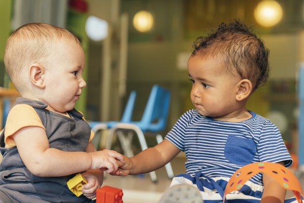 babies playing holding hands baby monitors